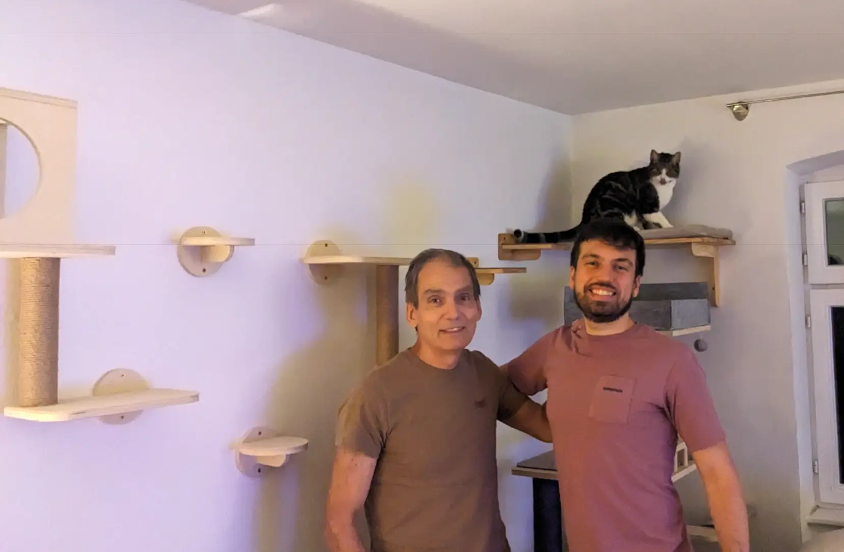 The finished cat wall, with Winston sitting on the large perch above us